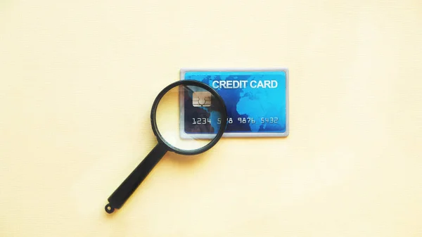 Credit card to pay for trips around the world and magnifier — Stock Photo, Image