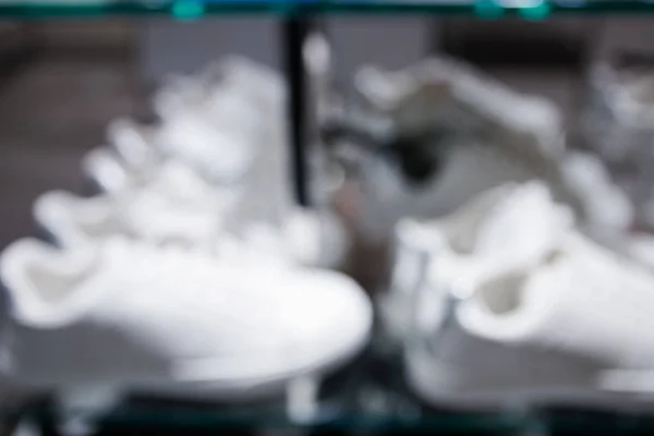 Blurry background of white sneakers in store — Stock Photo, Image