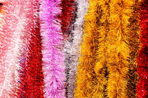 Festive Christmas decoration of colorful tinsel for the Christmas tree and house Stock Photo