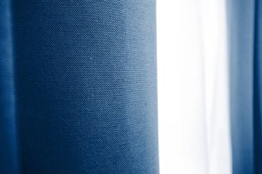 Koyu mavi karartma perdeleri ve yatak odasında beyaz tül, yatak odası dekorasyonu, mavi renk düzeni, sükunetin rengi.