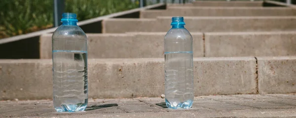 Two Plastic Bottles Clean Drinking Water Road Source Life Banner — Stock Photo, Image