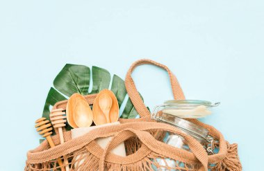 Pamuk torbası, cam kavanoz, yeşil yapraklar ve geri dönüşümlü masa örtüsü manzaralı plastik set. Sıfır atık, çevre dostu konsept. Düz yatıyordu.