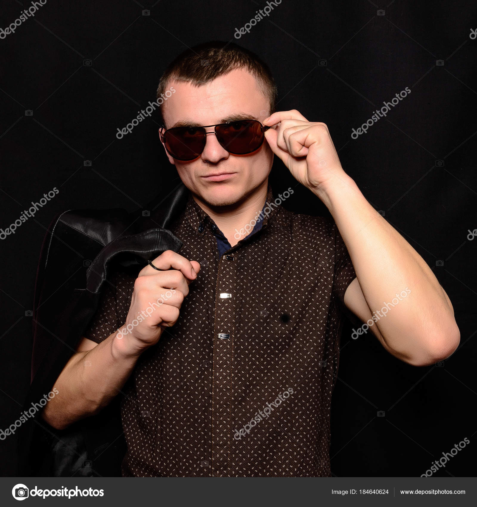 Studio Portrait Of A Young Guy With A Short Haircut In Brown