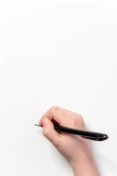 Mano de un niño pequeño con una pluma negra sobre un fondo blanco —  Fotos de Stock