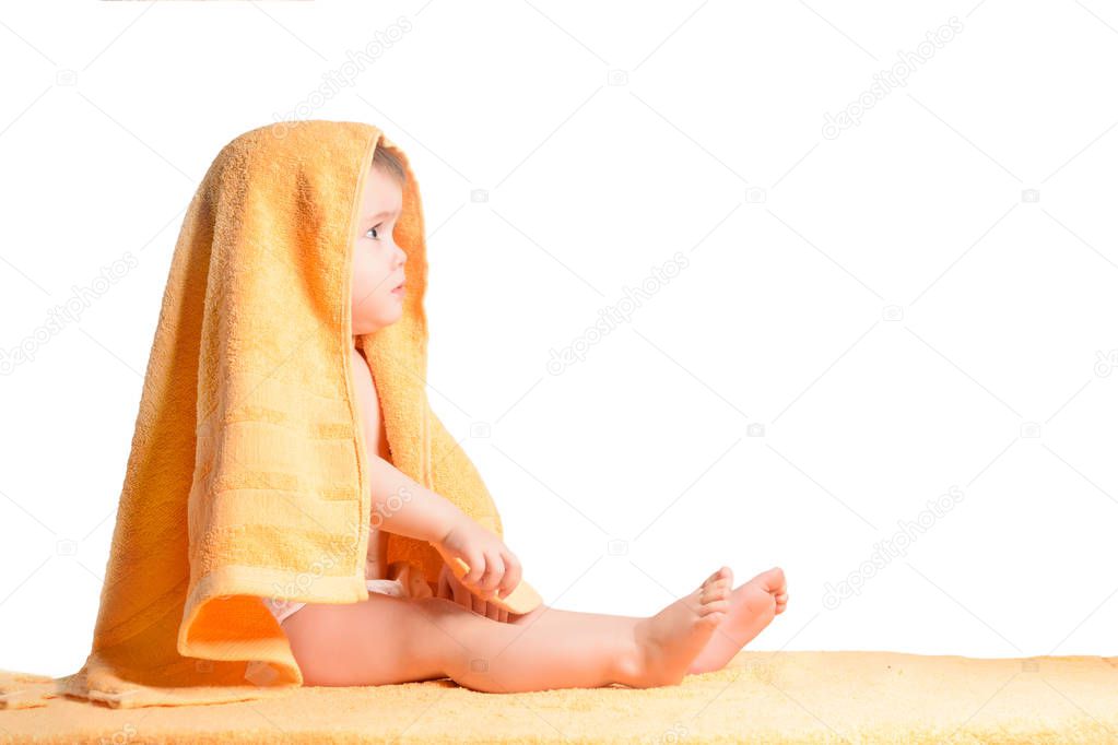 Little girl wrapped in yellow towel, isolated on white background