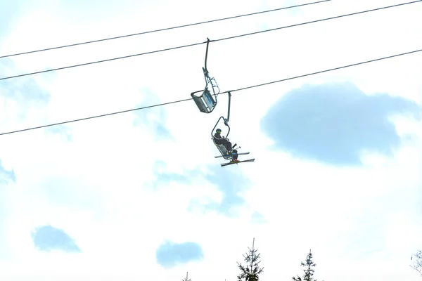 Bulutların üstündeki kayak merkezinde kayak sandalyesi kaldırma.. — Stok fotoğraf
