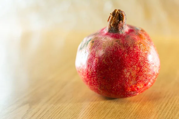 Roter reifer Granatapfel und brauner Hintergrund. — Stockfoto