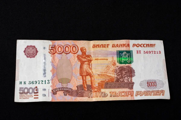 Una banconota russa per un importo di 5000 rubli si trova su uno sfondo nero . — Foto Stock