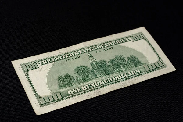 Rear side of old one hundred dollar american currency on black background. — Stock Photo, Image