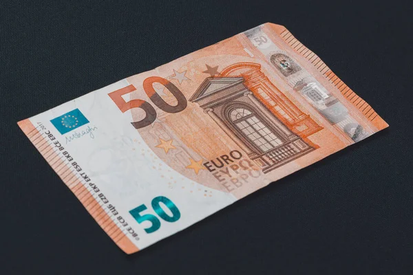 Fifty euro denominated paper money on a black background. — ストック写真