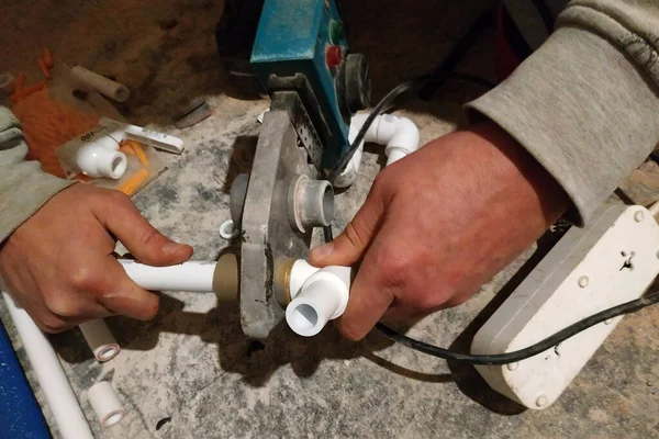 The worker soldered two tubes to heat the floor with a soldering iron. — 스톡 사진