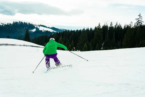 Um jovem está esquiando nos Cárpatos nas encostas . — Fotografia de Stock