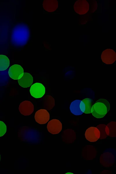 Bokeh of colored round festive Christmas lights. — Stock Photo, Image