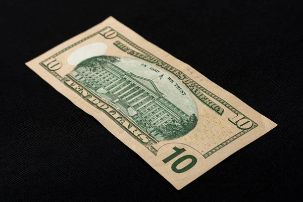 Tien Amerikaanse dollars liggen op de rug van een zwarte achtergrond.. — Stockfoto