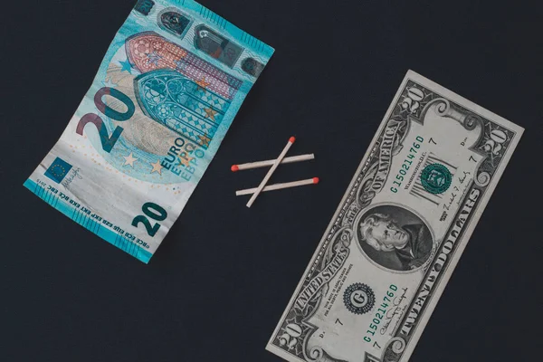 Euros and dollars on a black background, banknotes comparison. — Stok fotoğraf