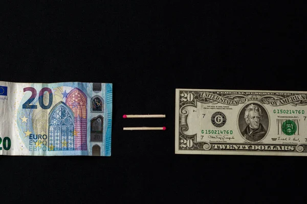 Euros and dollars on a black background, banknotes comparison. — Stok fotoğraf