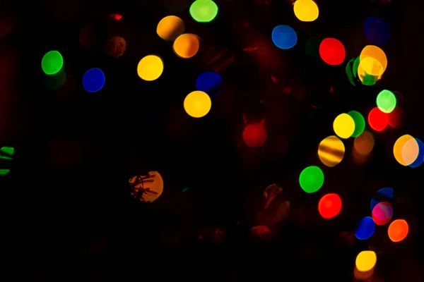 Orange, yellow, light red bokeh on black background. — Stock Photo, Image