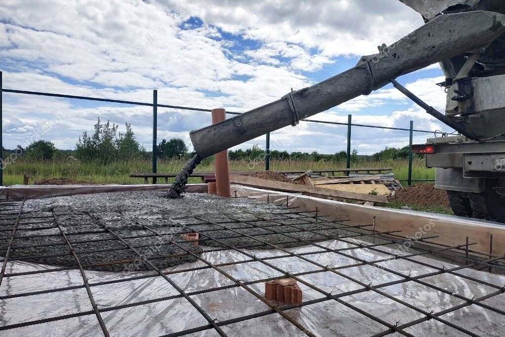 Pouring concrete after placing steel reinforcement to make a screed, the photo shows sewer pipes. 2019