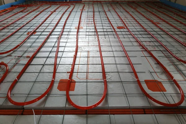 Installation of underfloor heating system, closeup on the water floor of the interior heating system of a new apartment building.2020