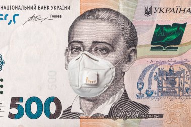 Banknote of 500 hryvnia depicting Gregory Skovoroda in a medical mask during the economic crisis and pandemic of the coronavirus. Qualitative montage closeup 2021. clipart