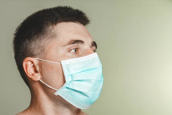 loseup of face male patient in medical mask on self isolation during coronavirus pandemic 2021