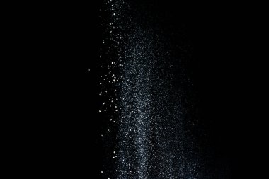 Kar veya un formunda beyaz toz, 2020 'de siyah zemin üzerinde tepeden tırnağa izole bir şekilde düşüyor.