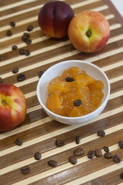 Orange yellow peach, nectarine jam with coffee beans - food photography
