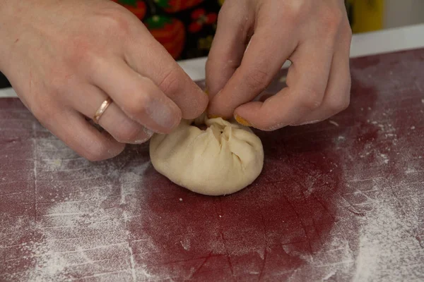 Chef cooks in the kitchen: molding of dough and meat Peremyach for a hot dish - Bashkir and Tatar cuisine, food photography