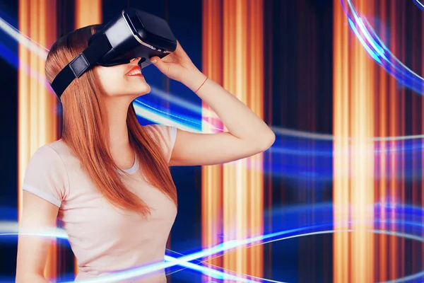 Woman looking with VR device and feeling excite and smile. Girl with glasses of virtual reality. Future technology concept. Abstract lines on background.