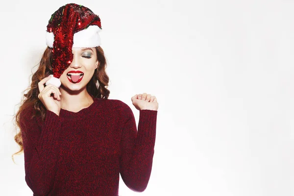 Schöne Mädchen in rotem Pullover und Weihnachtsmütze lächelt, lacht, wieder — Stockfoto