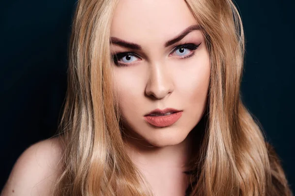 Blonďatá s dlouhými vlasy, dívající se do kamery. Profesionální make-up — Stock fotografie