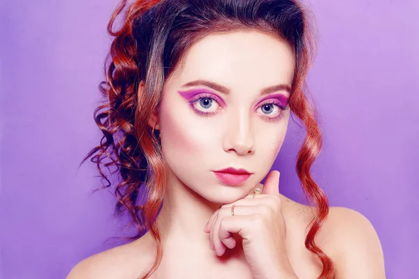 Beautiful young girl with purple make-up, on a purple background — Stock Photo, Image