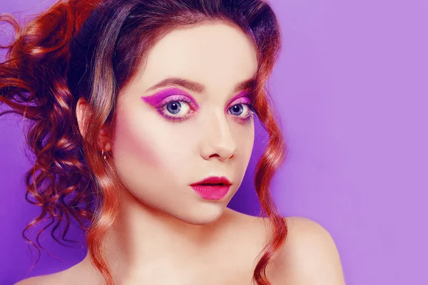 Beautiful young girl with purple make-up, on a purple background — Stock Photo, Image