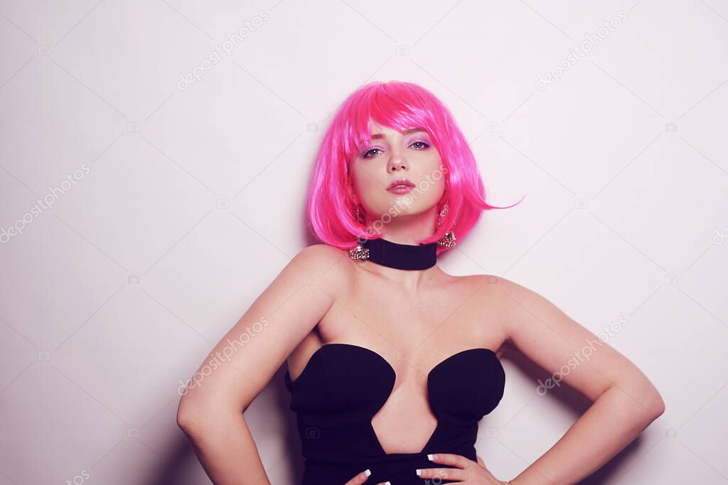 Girl on a white background posing, professional model. The girl with pink hair, mysterious, beautiful, looks at the camera, flirts, flirts. Long pink earrings. Incredible look.