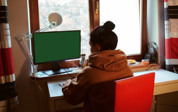 Menina Está Sentada Casa Mesa Computador Com Ecrã Verde Home — Fotografia de Stock