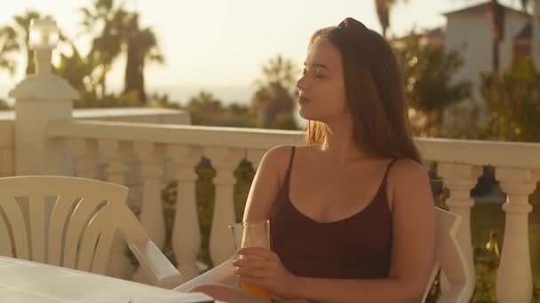 Girl Sits Terrace Backdrop Sunset Summer Dawn Woman Drinks Coffee — Stock Video