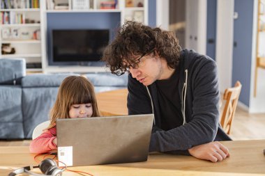 Young father working from home with little daughter during covid-19 lockdown. Child with dad smartworking on laptop for social isolation. clipart