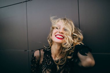 Çatıda poz siyah elbiseli çekici sarışın