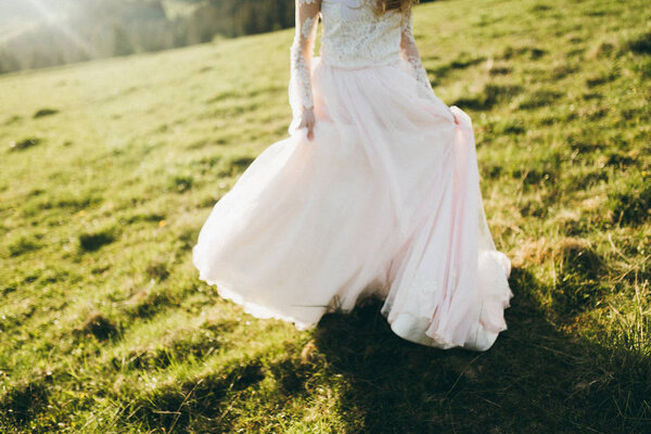 Delicate beautiful bride posing outdoors