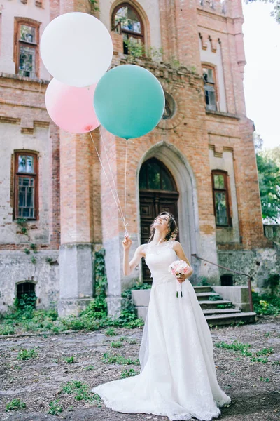 城堡附近的年轻新娘与气球 — 图库照片