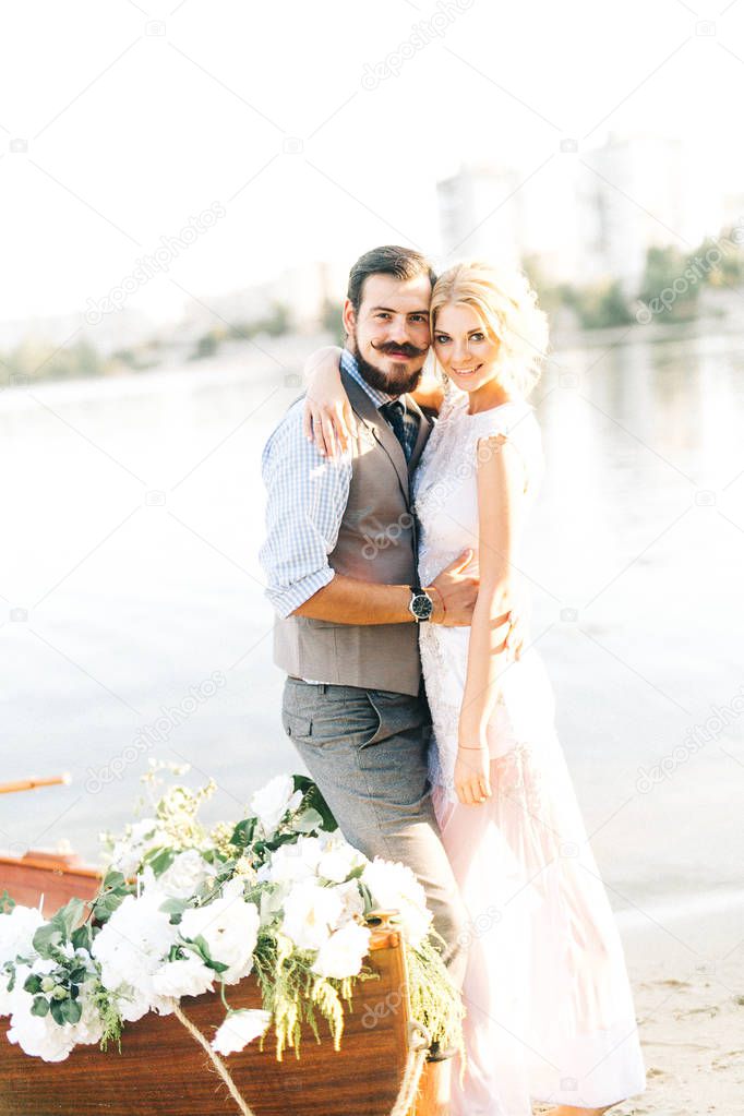 young wedding couple near  boat posing