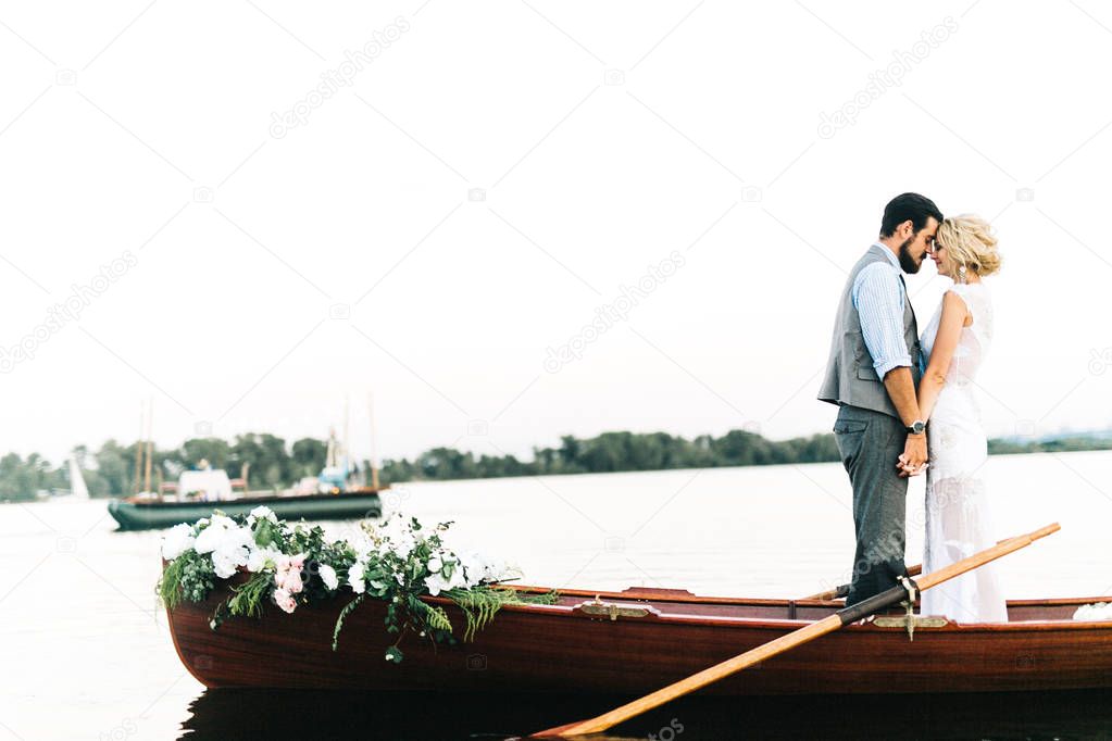 young wedding couple posing on boat 