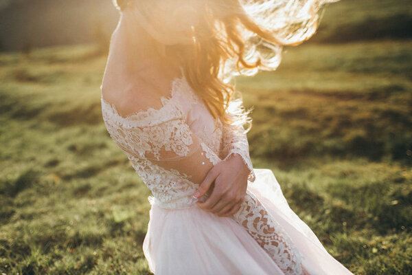 Delicate beautiful bride posing outdoors