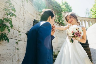 yeni evliler merdivenlerinde poz güzel birkaç. damat öpüşme gelinin el