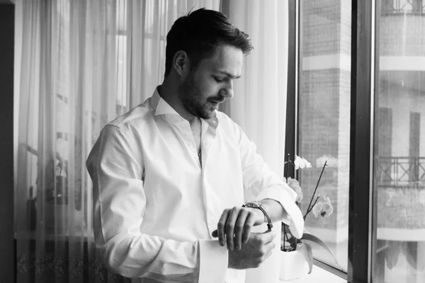 young handsome  man looking at watch