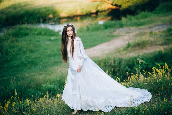 Young beautiful bride posing outdoors