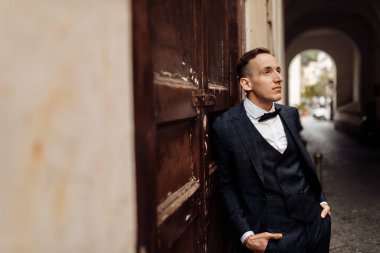 Genç yakışıklı adam, damat poz veriyor.