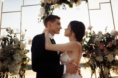 Güzel, genç bir çift yeni evli poz veriyor.