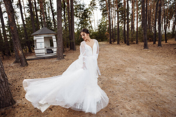 Delicate beautiful bride in the forest
