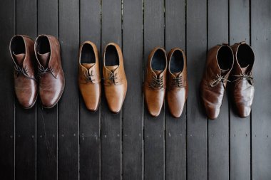 The brown shoes on the black wooden floor, Leather. clipart